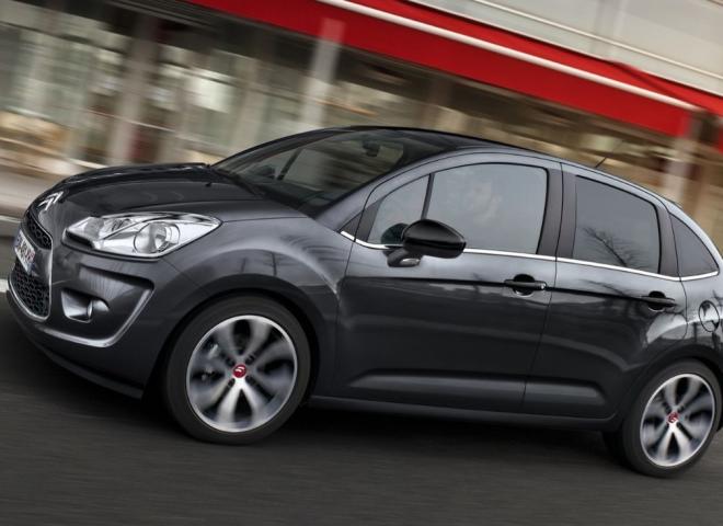 Une Citroën C3 d'occasion noire d'ancienne génération roulant en ville